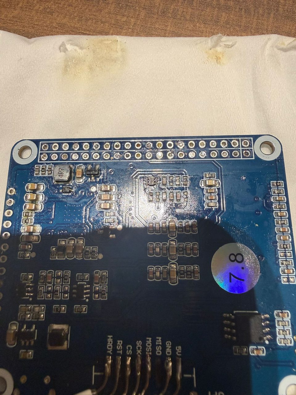 The prototype driver board hand-soldered and hot-glued into a piece of white packing foam.