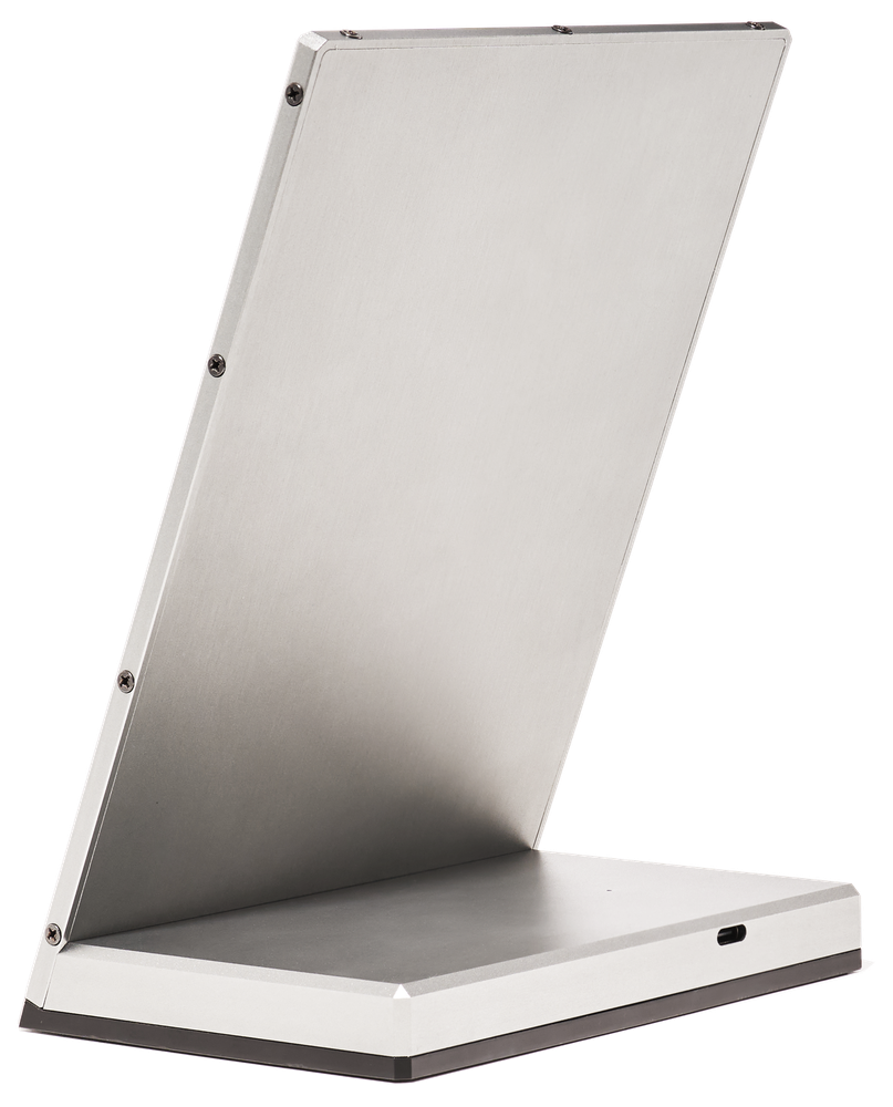 The machined 6061-aluminium body of the Newsboard from the rear three-quarter: a brushed face, a crisp chamfered edge, recessed corner screws and the wedge base.